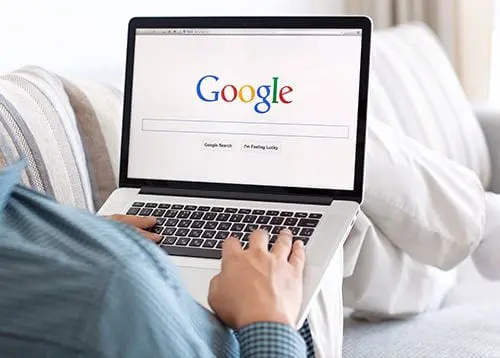 Man using Google on laptop