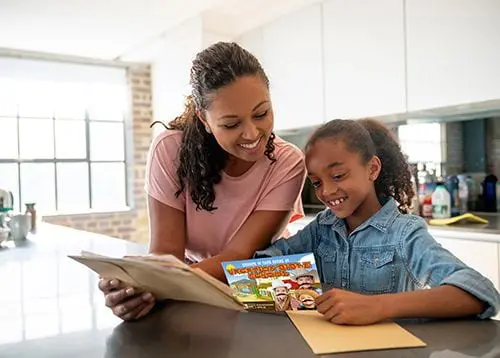 Mother and child reading a targeted church mailer