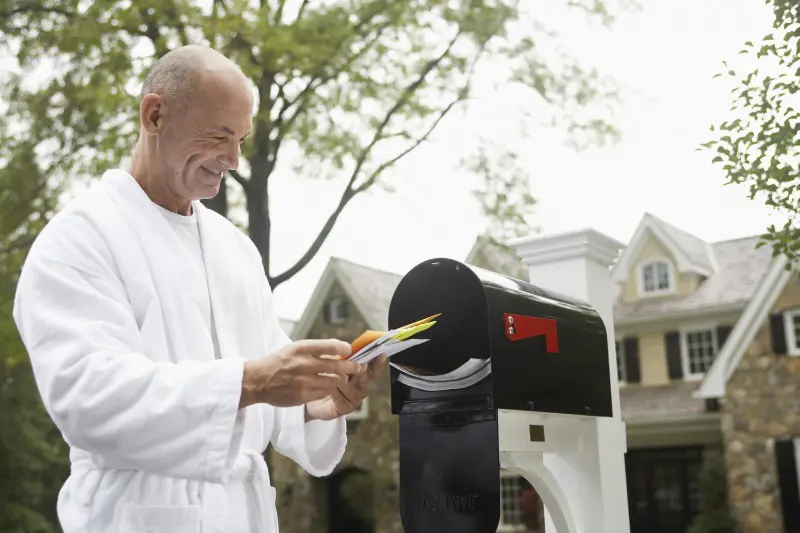 A man finds personalized direct mail in his mailbox