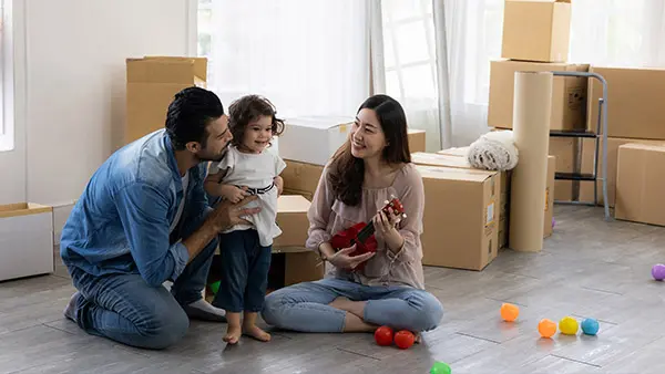 Webinar - New Movers Help Grow Your Church - image of happy family who just moved into new house with boxes on the floor